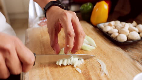 Cooking,-cutting-onion-and-hands-of-chef-making