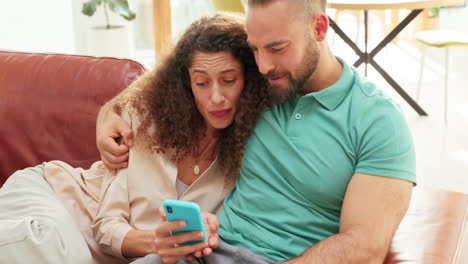 Couple,-relax-and-on-sofa-with-phone-on-social