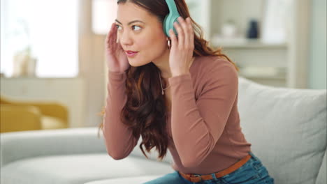 Woman,-phone-or-music-headphones-on-relax-sofa