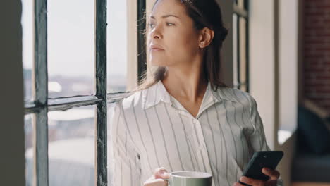 Woman,-phone-and-coffee-thinking-at-window