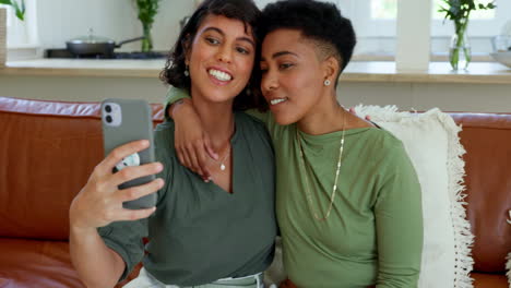 Phone,-selfie-and-lesbian-couple-relax-on-a-sofa
