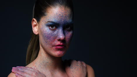 Face-paint,-art-makeup-and-woman-against-a-dark