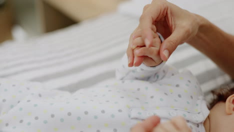 Mother,-baby-and-holding-hands-in-care