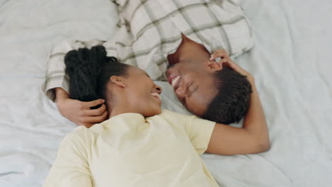 Couple,-black-woman-and-kiss-on-bed-together