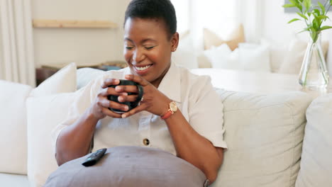Black-woman,-coffee-and-relax-watching-tv-on-sofa