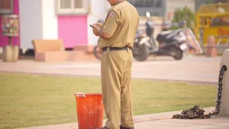 Indian-police-man-using-mobile-phone