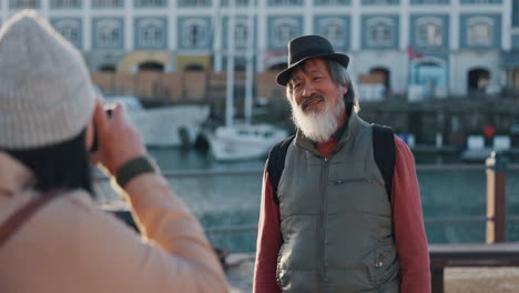 Man,-elderly-and-photo-as-tourist-pose-on-dock-by