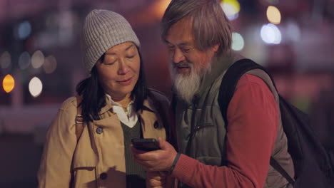 Night,-phone-and-senior-couple-in-the-city