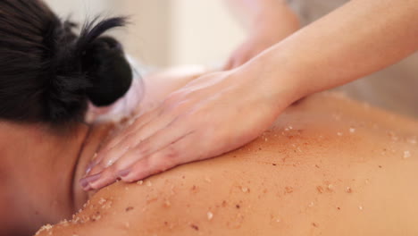 Spa,-massage-and-salt-scrub-on-back-of-woman