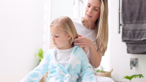 Girl,-mother-and-brush-hair-in-bathroom-home