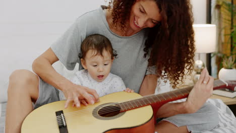 Happy,-family-and-baby-learning-guitar