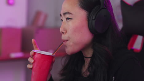 Asian,-woman-and-gamer-at-computer-eating