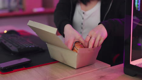 Gaming,-fast-food-and-asian-woman-eating-burger