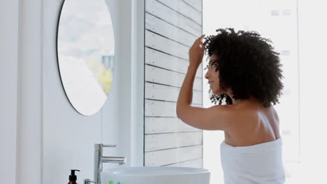 Black-woman,-afro-and-hair-care-in-house-bathroom