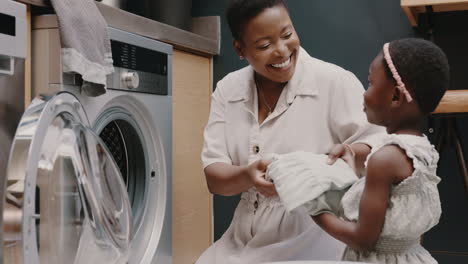 Laundry,-mother-and-child-helping-with-folding
