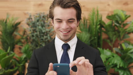 Business-man,-phone-and-green-plant-background-to