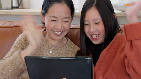 Asian-mom,-girl-on-tablet-video-call