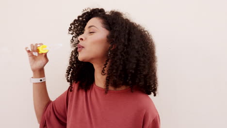 Black-woman,-blowing-bubbles