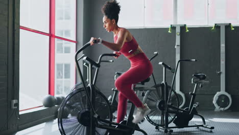 Exercise-bike,-cardio-and-girl-cycling-for-sports