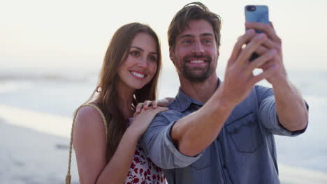 Love,-beach-and-couple-taking-a-selfie-with-phone