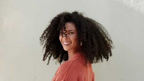 Afro-woman-shaking-natural-hair-curls-with-white
