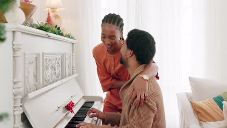 Christmas,-piano-music-and-couple-singing-festive
