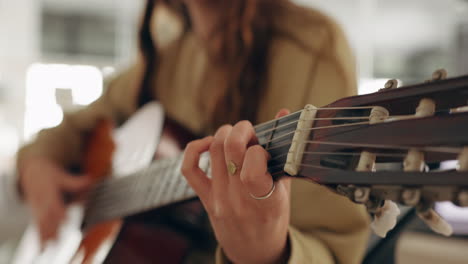Hands,-music-and-guitar-by-woman-artist-playing