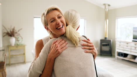 Friends,-greeting-and-senior-women-hug-in-living