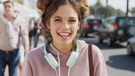 Woman,-headphones-and-smile-portrait-in-city
