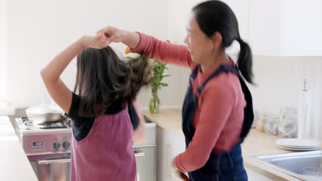 Music,-dance-and-mother-with-girl-in-a-kitchen