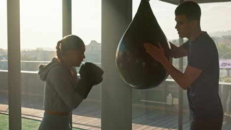 Training,-gym-and-woman-boxing-with-a-coach