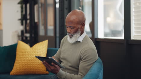 Tablet,-technology-and-senior-black-man-on-sofa