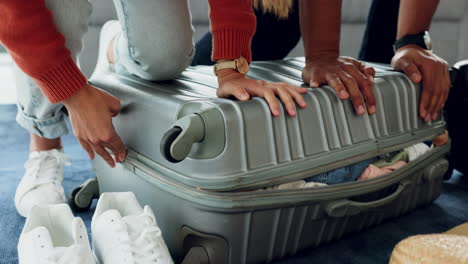 Couple,-packing-and-full-travel-suitcase