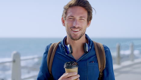 Man,-smile-portrait-and-coffee-on-beach-for-travel