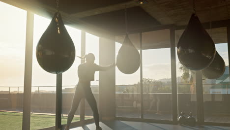 Gym,-woman-and-boxer-punching-bag-for-martial-arts