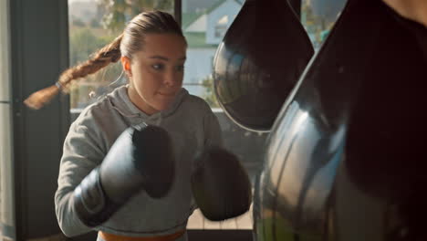 Boxer,-woman-and-punching-bag-for-exercise