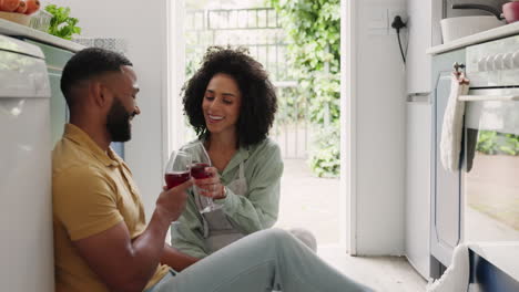 Happy-couple,-wine-and-toast-on-kitchen-floor