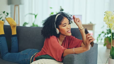 Headphones,-phone-and-black-woman-dance-on-sofa
