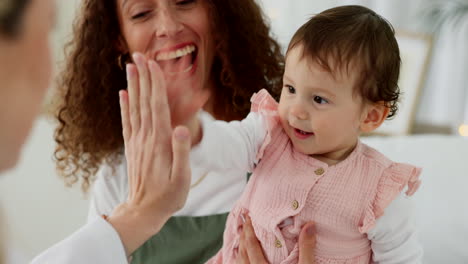 Doctor,-wellness-and-high-five-with-happy-baby