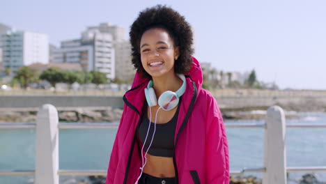 Black-woman,-afro-and-headphones-in-beach-fitness