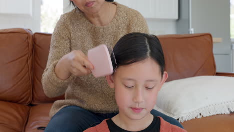 Mother,-Asian-girl-and-brush-hair-for-childcare