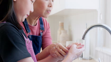 Child-washing-her-hands-with-her-mother