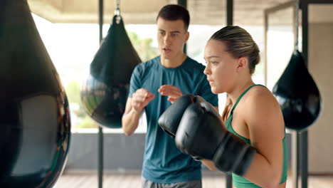 Coach,-woman-and-punching-bag-while-training