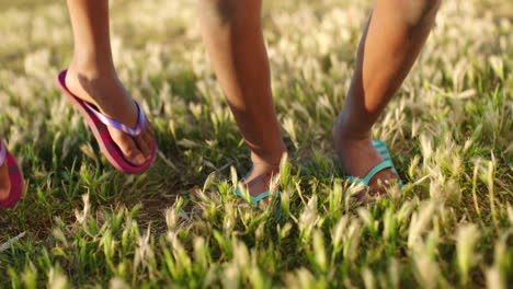 Kids,-summer-and-feet-jump-on-grass-with-flip