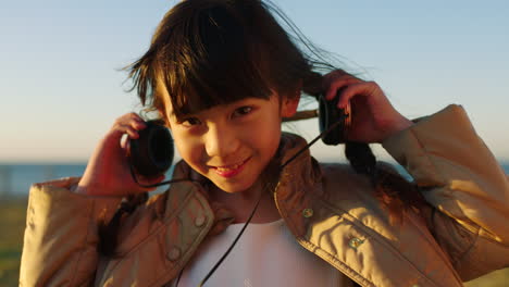 Child,-face-smile-and-beach-with-headphones