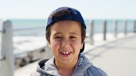 Face,-smile-and-happy-kid-at-beach-on-vacation