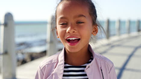 Child,-face-and-surprised-girl-by-beach