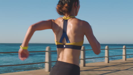 Back-view,-woman-and-running-with-speed-at-beach