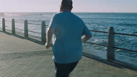 Fitness,-plus-size-and-man-running-along-beach