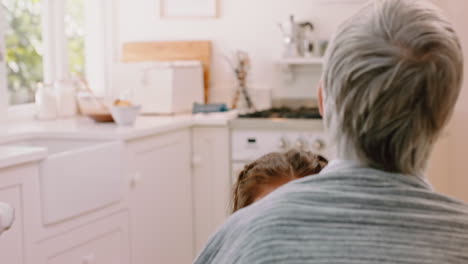 Love,-hug-and-grandmother-with-girl-in-kitchen